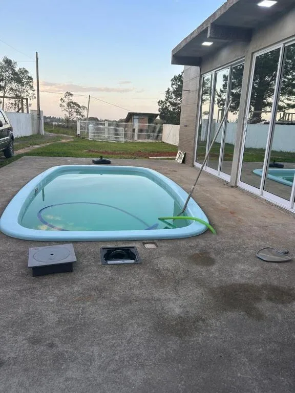 Casa com três quartos, piscina e área Gourmet, Torres, na Rua Dionel Ferro em Torres/RS — foto 6